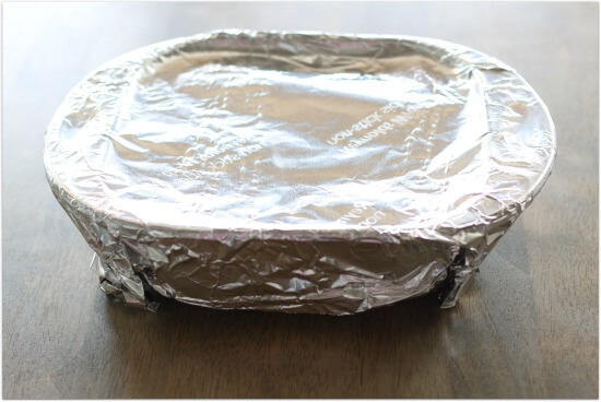 cover the dish tightly with foil before placing it in the oven