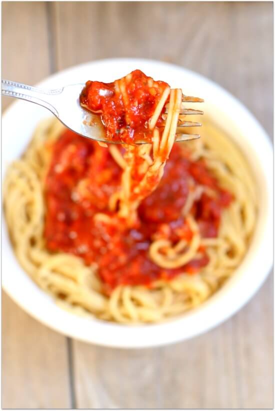 Slow Cooker Spaghetti Sauce: Don't buy cans or jars spaghetti sauce at the grocery store...make it at home! Make it at home in your slow cooker. It's super easy and tastes amazing after simmering all day long. Make a huge batch and freeze the leftovers for an easy dinner another night.