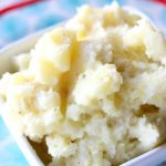 Slow Cooker Buttermilk Mashed Potatoes--these are my favorite mashed potatoes. Cubed potatoes are cooked for a few hours in your slow cooker with garlic cloves and bay leaf. Then they're mashed with butter and buttermilk for ultimate creaminess and flavor.