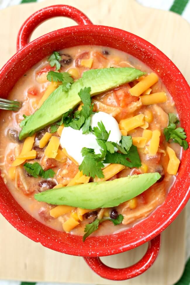 Slow Cooker Creamy Tortilla Soup is a dump and go crockpot recipe that tastes amazing! We love topping ours with avocado, tortilla chips, cheese and sour cream.
