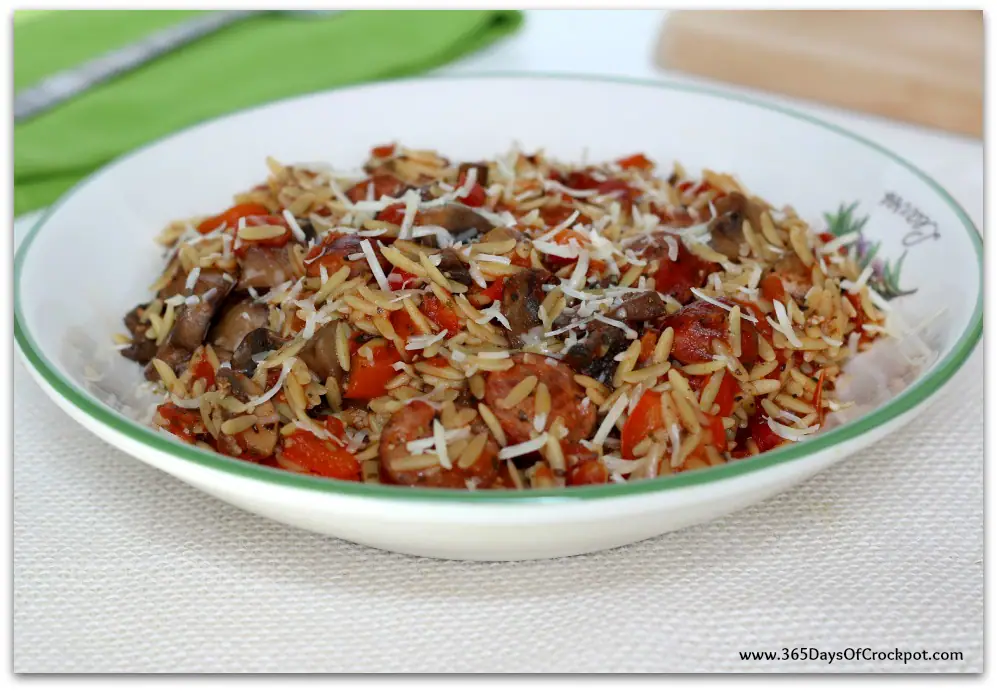 Instant Pot Parmesan Sausage Orzo--smoked sausage, peppers, mushrooms, tomatoes, orzo and parmesan cheese cooked quickly in your pressure cooker. This meal is loaded with flavor and is a dump and go one pot meal. 