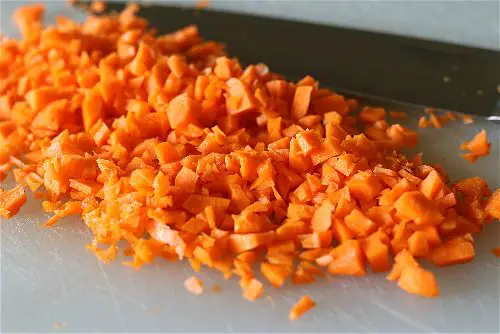 Finely diced carrots for a mirepoix--tomato soup recipe