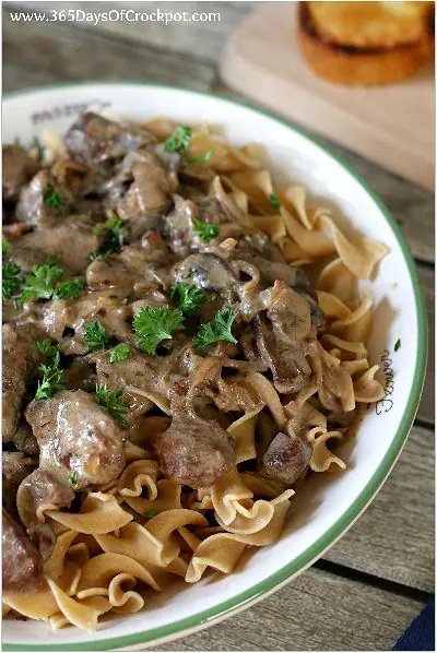 Recipe for French Onion Beef Stroganoff. Caramelized onions, tender beef chunks and mushrooms served over egg noodles. All made in the slow cooker!