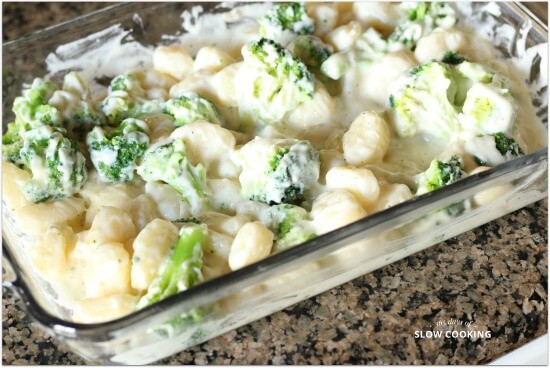 Creamy cheese sauce on top of broccoli and gnocchi