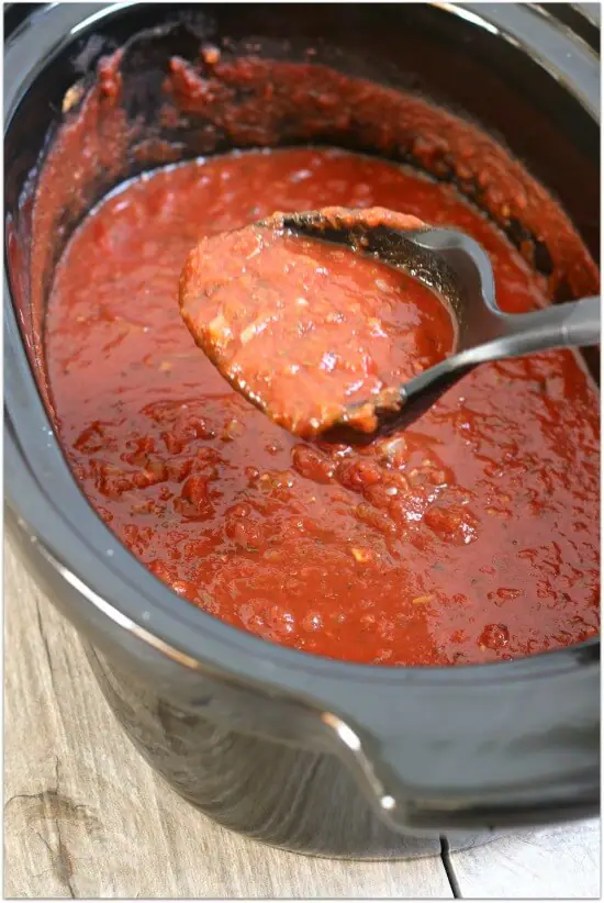 Slow cooker spaghetti sauce recipe: Don't buy cans or jars spaghetti sauce at the grocery store...make it at home! Make it at home in your slow cooker. It's super easy and tastes amazing after simmering all day long. Make a huge batch and freeze the leftovers for an easy dinner another night.