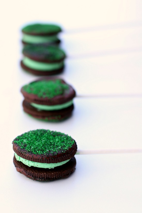 Chocolate dipped mint oreo pops with green sprinkles. These easy to make treats are perfect for St. Patrick's Day and they taste amazing. I think they taste like a cross between oreos and Girl Scout Thin Mints. 