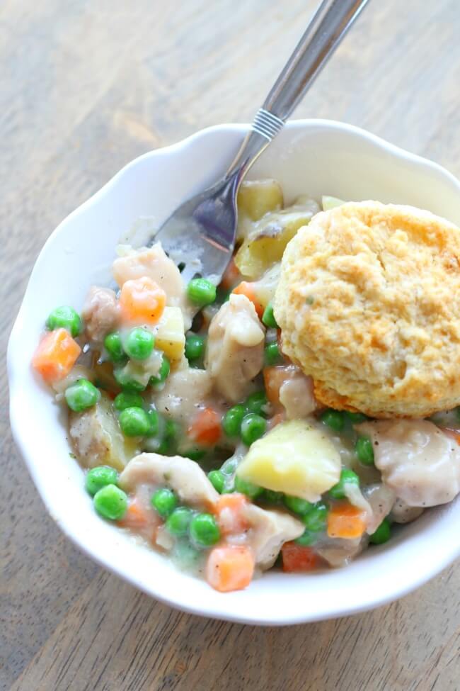 Back to school Instant Pot recipes--Easy and delicious recipe for chicken pot pie in the crockpot--peas, carrots, potatoes and chicken with a cream sauce and flaky biscuits