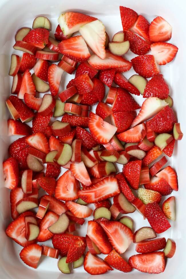 sliced strawberries and rhubarb in a casserole crock