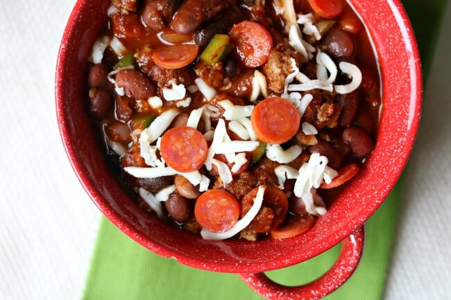 Slow Cooker Pepperoni Pizza Chili is the perfect chili for a chilly (get it?) evening or for tailgating. It is packed with mini pepperonis, Italian sausage and green peppers to give you all your favorite pizza flavors. Plus it's of course topped with melty mozzarella cheese. 