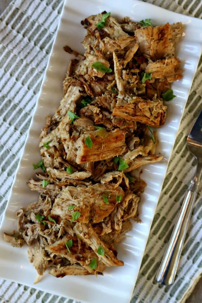 Skinny Slow Cooker Pork Carnitas: lean pork cooked in your slow cooker with onion, garlic, jalapeno, and lots of spices then crisped up on the stove top in a little olive oil creating maximum flavor for tacos, salads, burritos, nachos and enchiladas. 