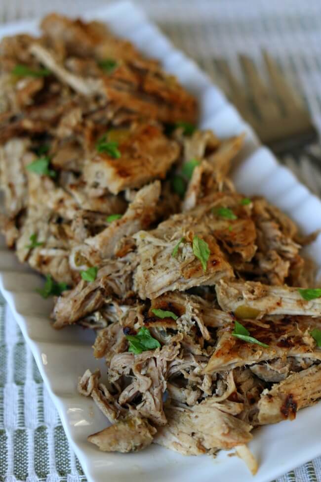 Skinny Slow Cooker Pork Carnitas: lean pork cooked in your slow cooker with onion, garlic, jalapeno, and lots of spices. Then the pork is crisped up on the stove top in a little olive oil creating maximum flavor for tacos, salads, burritos, nachos and enchiladas. 