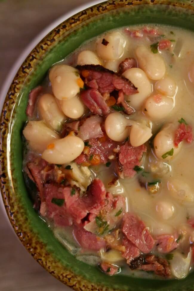 Slow Cooker White Bean and Pastrami Soup--an easy recipe for a creamy crockpot soup made with dried white beans, chopped vegetables, flavorful seasonings and salty pastrami (or you can use ham). 
