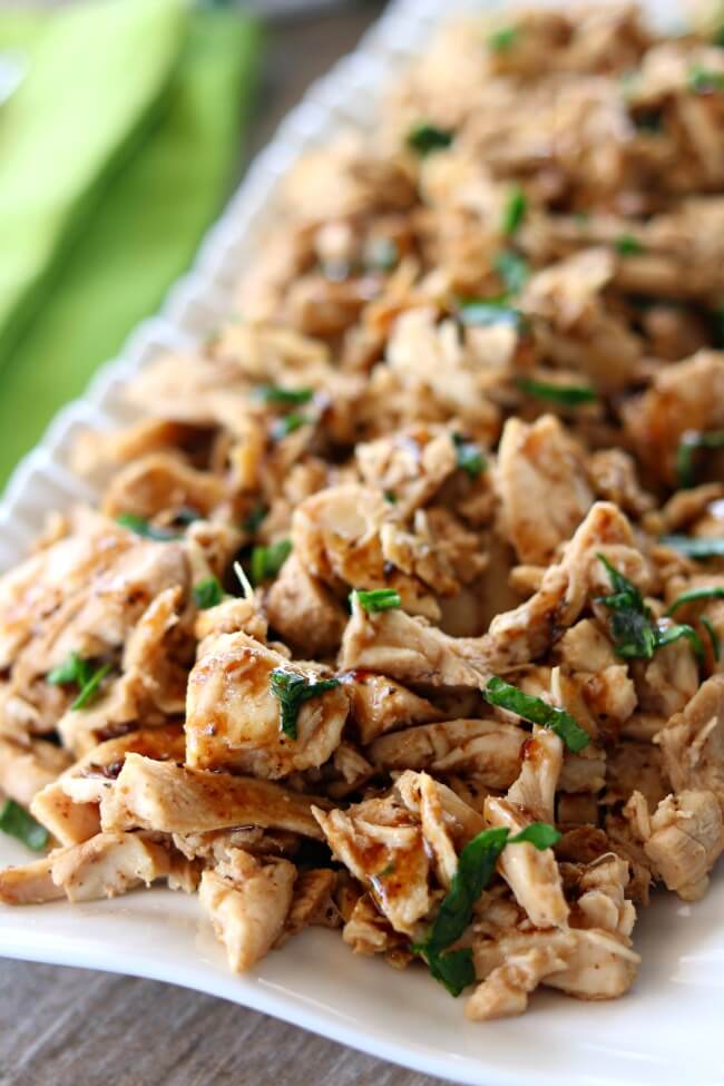 Slow Cooker 2-Ingredient Balsamic Chicken--tender, moist bites of shredded chicken flavored with a light balsamic dressing. With literally only 2 ingredients and the fact that it's made in the crockpot, this recipe couldn't be easier to make. This balsamic chicken tastes great on salads, over rice or with a baked potato.