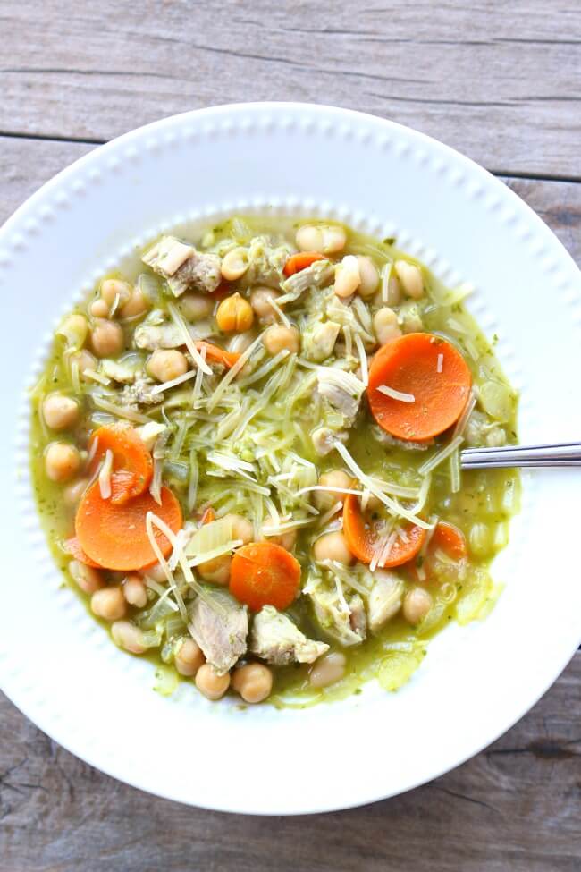 Slow Cooker Chicken Pesto Bean Soup--moist bites of chicken, tender chickpeas and white beans, carrots, celery and onions all cooked in a broth flavored with basil pesto. 