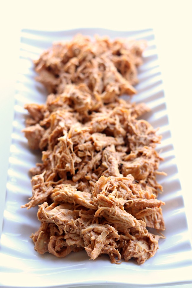 Instant Pot Shredded BBQ Cream Cheese Chicken Recipe--tender chicken breasts cooked in minutes in your pressure cooker and then mixed with cream cheese and BBQ sauce. This chicken is addictive! Perfect to serve on sandwiches, rolled up in tortillas or on pizza. 