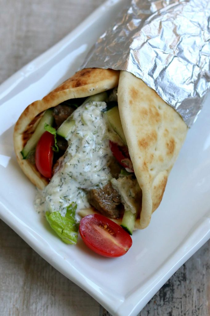 Instant Pot Beef Gyros-Tender pieces of beef with soft onions, juicy tomatoes, crispy lettuce, creamy cucumber yogurt sauce, all wrapped in soft pita bread and melted in the mouth. The meat is cooked until tender in its electric pressure cooker in less than an hour.