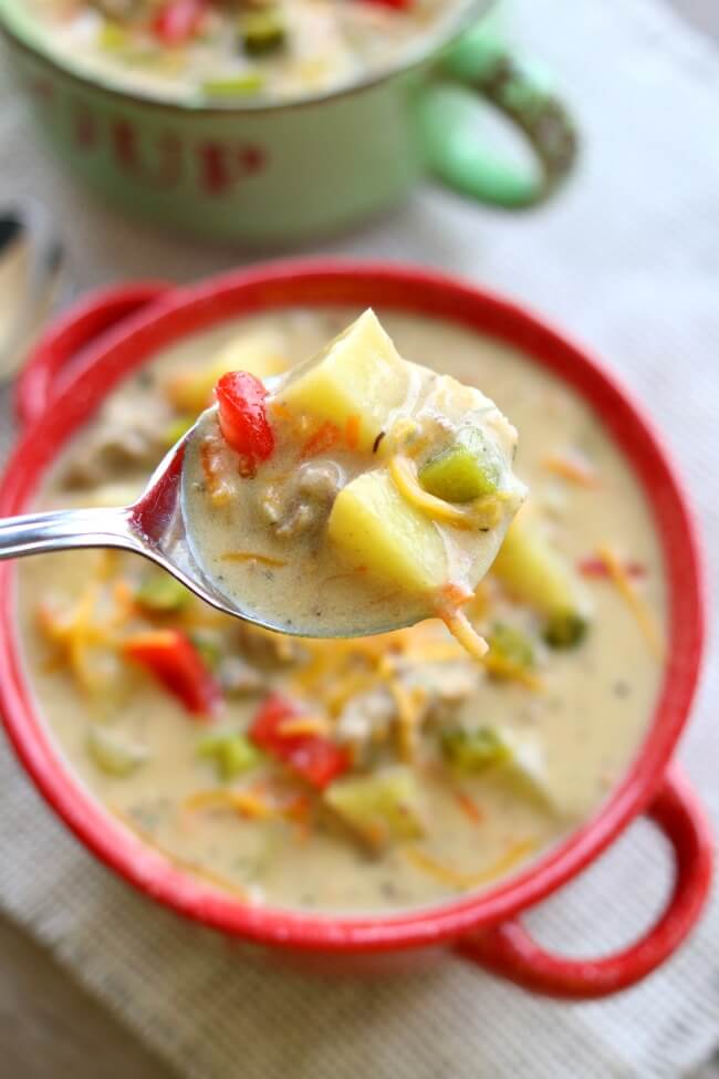 Instant Pot Cheeseburger Soup--creamy and cheesy soup that is made so fast in your electric pressure cooker. Serve it with diced up dill pickle and tomatoes to get that authentic cheeseburger taste. Add crumbled bacon for bacon cheeseburger soup! Miss the bun? Make homemade croutons out of a toasted sesame seed bun to get the total effect. Bottom line...you need to make this today!