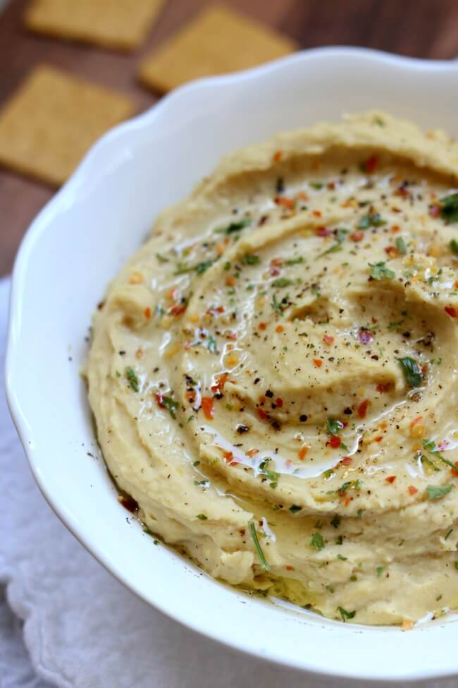 Instant Pot Hummus (without Tahini)--you can cook dried chickpeas in a pressure cooker and make your own hummus from scratch. This recipe has simple ingredients, like olive oil, garlic and lemon juice, that you probably already have on hand. 