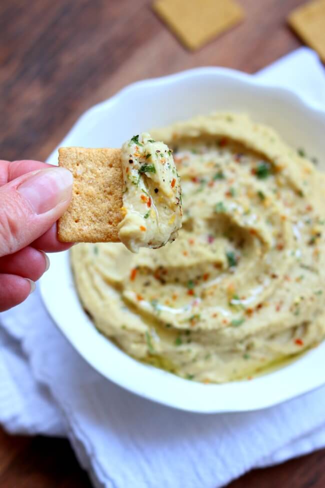 Instant Pot Hummus (without Tahini)--you can cook dried chickpeas in a pressure cooker and make your own hummus from scratch. This recipe has simple ingredients, like olive oil, garlic and lemon juice, that you probably already have on hand. Hummus is a creamy and healthy dip that is perfect with crackers or raw veggies.