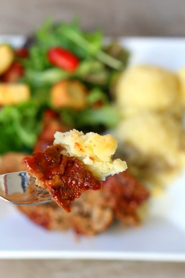 Instant Pot Bacon Barbecue Meatloaf with Mashed Potatoes--the best flavored meatloaf ever is cooked at the same time and in the same pressure cooker as your mashed potatoes. Add a tossed salad and you have a complete meal ready to go in just a few minutes. 