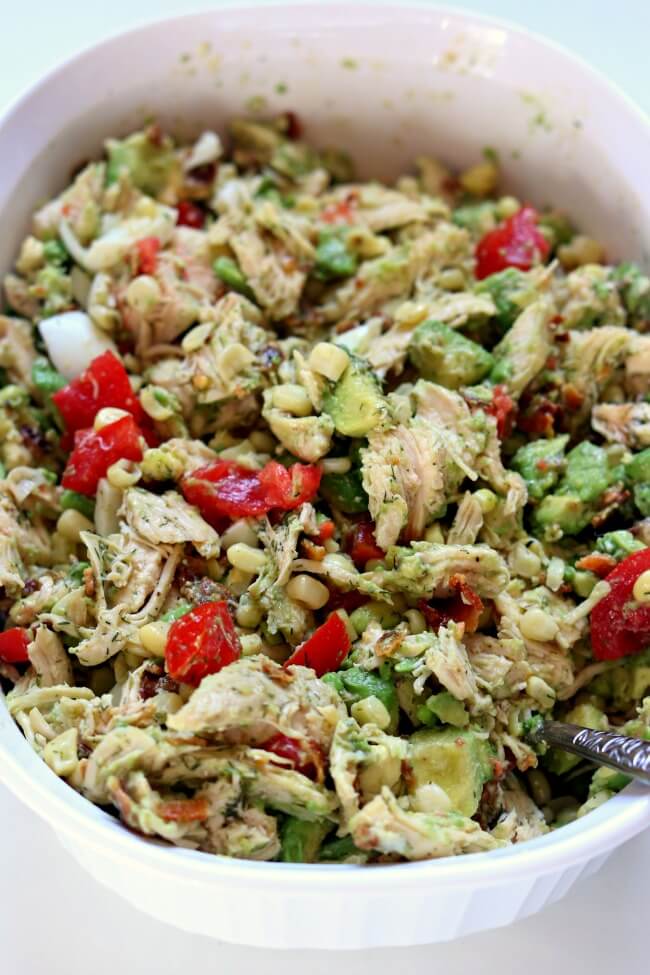 Instant Pot Chicken Bacon Avocado Salad--shredded chicken breasts and hard boiled eggs are cooked at the same time in your Instant Pot and then combined with corn, bacon, green onion, tomatoes and a lemon dill dressing. A fresh and surprisingly filling entree or side dish. 