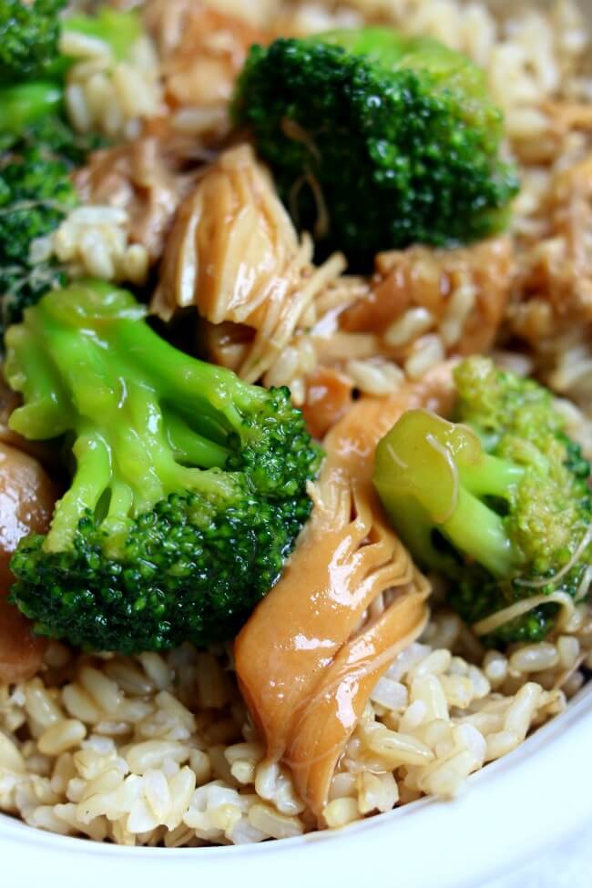 Instant Pot Chicken Broccoli Rice Bowl--brown rice is topped with a savory asian-inspired sauce, tender pieces of chicken and bright green, barely cooked broccoli florets.  