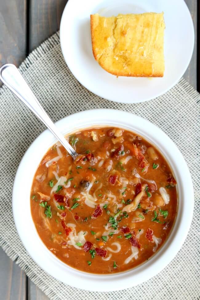 Slow Cooker Bean and Bacon Soup--dried beans are cooked all day in your slow cooker along with carrots, celery, garlic and bacon. A simple but seriously delicious soup that will leave you wanting seconds (and the leftovers the next day are even better than the first day).
