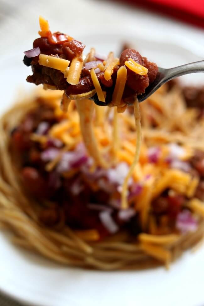 Instant Pot/Slow Cooker Cincinnati Chili--Cincinnati chili is a Mediterranean-spiced meat sauce used as a topping for spaghetti. There are many ways to make it but in this recipe we're going five way: spaghetti, chili with beans, shredded cheese and diced red onions. You can make the chili in the Instant Pot or the slow cooker, it's your choice.
