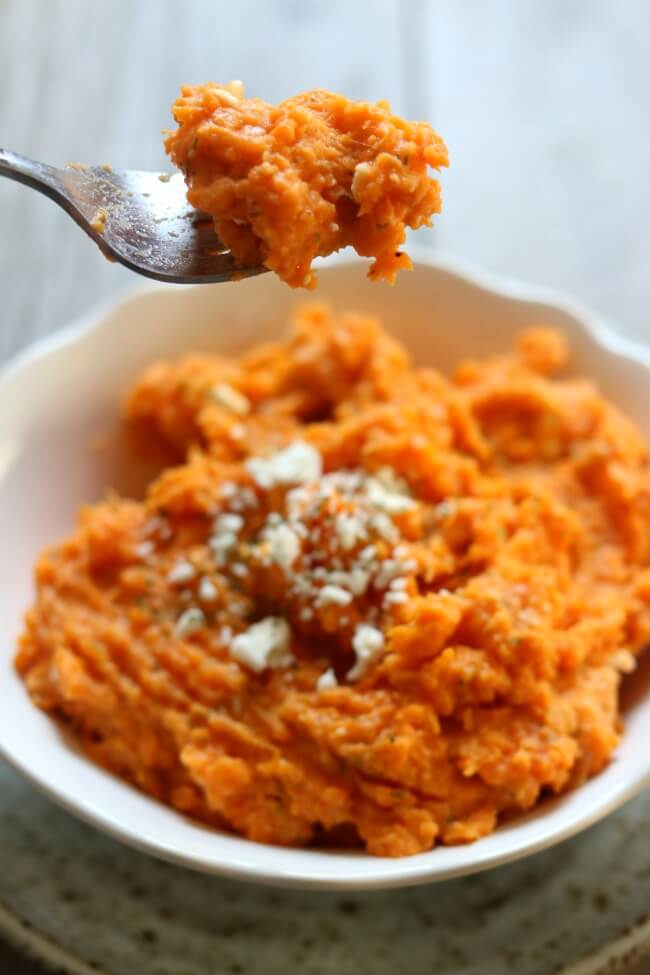 Slow Cooker Feta Dill Sweet Potato Mash--creamy mashed sweet potatoes made with garlic, feta and dill for ultimate flavor. This side dish frees up your oven and stove since it's made in the slow cooker. 