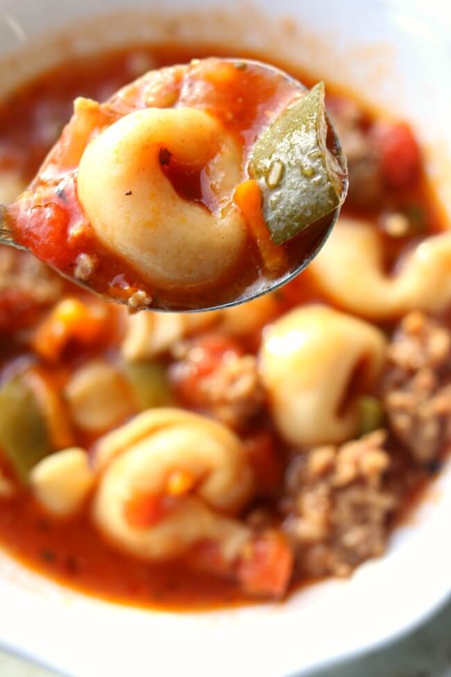 Instant Pot Italian Tortellini Soup--Italian sausage is browned with onions and garlic and then beef broth, tortellini, tomatoes, green peppers and zucchini are simmered together to produce a soup with ultimate flavor. 