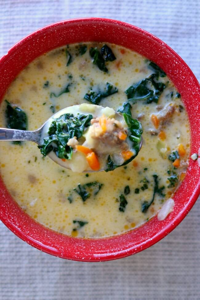 Instant Pot Parmesan Sausage Kale Soup--A creamy and comforting soup that is full of flavor thanks to loads of Parmesan cheese and Italian sausage.  Good thing this recipe makes a lot because everyone will be asking for seconds!