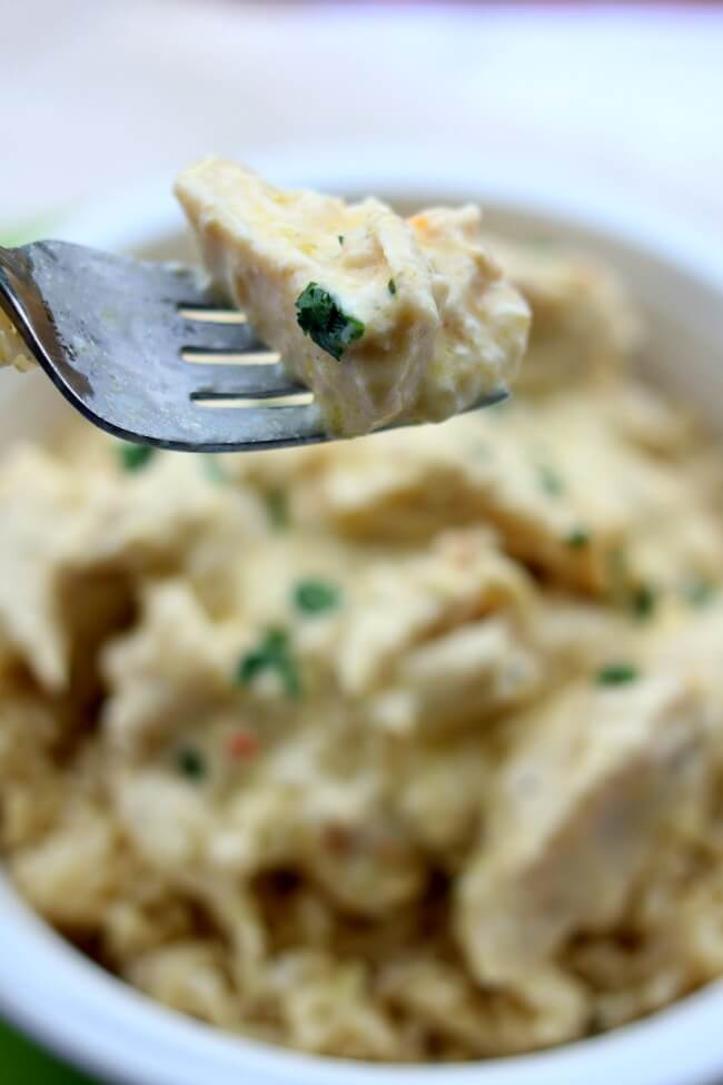 Instant Pot Creamy Chicken--the easiest cheater recipe out there. Chicken, cream cheese, cream of chicken soup and an Italian dressing mix packet are combined to make a delicious chicken and rice dinner with hardly any work. This version is made in your electric pressure cooker in just a few minutes. 