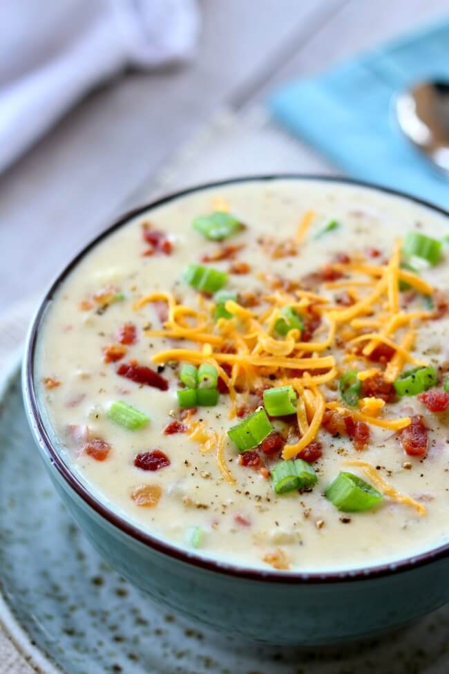 Instant Pot Baked Potato Soup--everything you love about baked potatoes in soup form...cheese, bacon, sour cream, green onions and potatoes. Basically a cheesy potato soup recipe that you can make in your electric pressure cooker. 