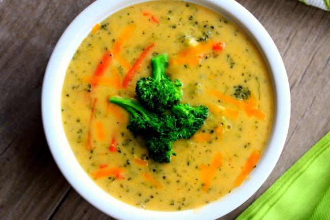 Slow Cooker Panera Broccoli Cheddar Soup--reminiscent of Panera Bread's broccoli cheddar soup this slow cooker version has chopped broccoli, shredded carrots and celery simmered in a velvety smooth cheese sauce. I believe this version is just as good or better than you could order at any restaurant! Try it for dinner this week. 