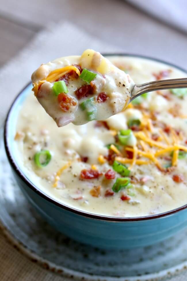 Instant Pot Loaded Baked Potato Soup--everything you love about baked potatoes in soup form...cheese, bacon, sour cream, green onions and potatoes. Basically a cheesy potato soup recipe that you can make in your electric pressure cooker. 