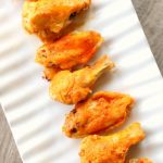 Instant Pot Buffalo Wings--throw a bag of frozen chicken wings in your electric pressure cooker and cook for just 4 minutes, baste with delicious buffalo wing sauce and broil in your oven for another 4 minutes and you have super tender and flavorful wings.