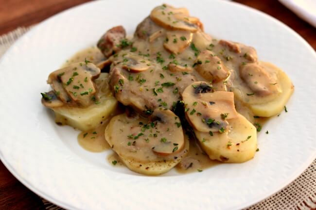 Slow Cooker Pork Shoulder Steaks with Mushrooms, Potatoes and Gravy--Pork steaks are browned and then cooked until tender. They are served alongside a mushroom gravy and sliced potatoes. A good old fashioned dinner!