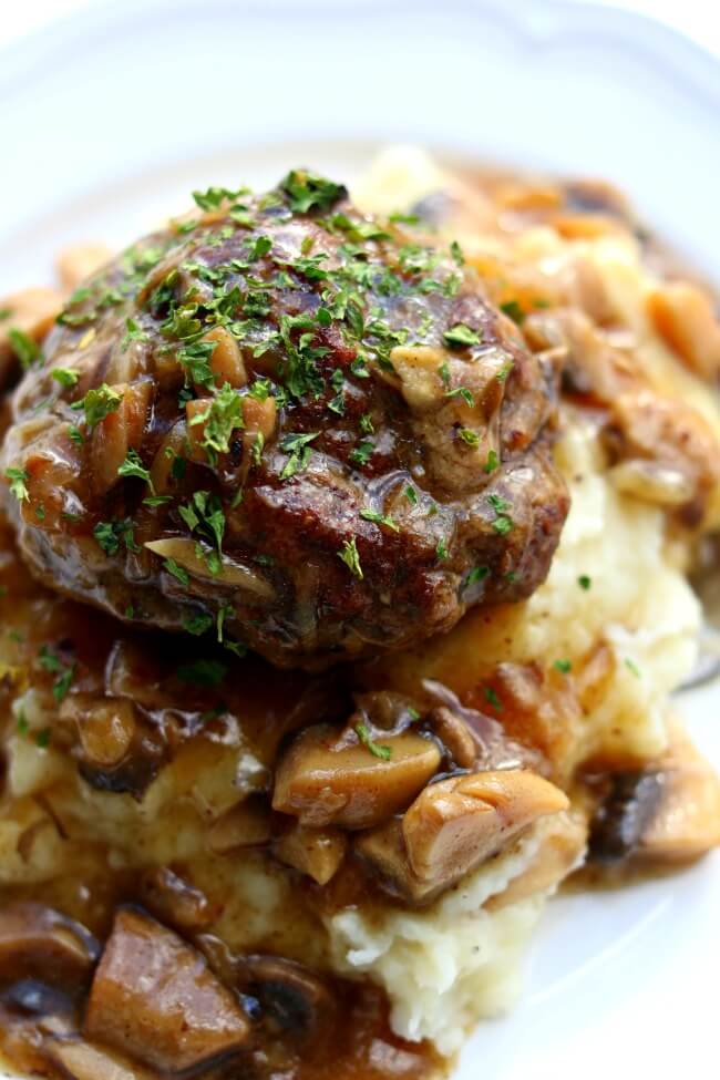 Instant Pot Salisbury Steak, Gravy and Mashed Potatoes-good old fashioned Salisbury steak is prepared in its pressure cooker with a tasty mushroom and onion sauce and creamy mashed potatoes. An amazing home-cooked meal from a pot that will throw away any TV dinner you have in your freezer.