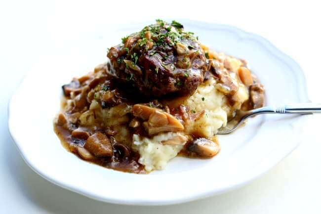 Instant Pot Salisbury Steak, Gravy and Mashed Potatoes--good old fashioned salisbury steak is prepared in your pressure cooker with a savory mushroom and onion gravy and creamy mashed potatoes. An amazing homemade one pot meal that will have you throwing away any TV dinners that you have in your freezer.