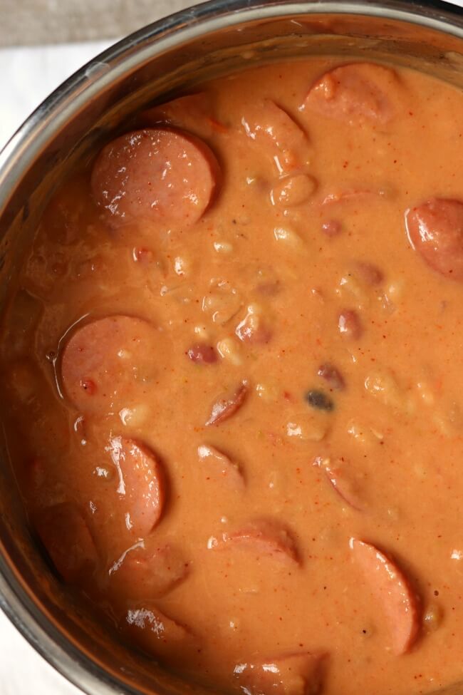 Instant Pot/Slow Cooker Creamy 15 Bean Soup--the classic 15 bean soup recipes with a creamy twist! You're going to love this thick and creamy bean soup with smoked sausage or ham. Make it fast in your pressure cooker or let it simmer all day in your slow cooker. 