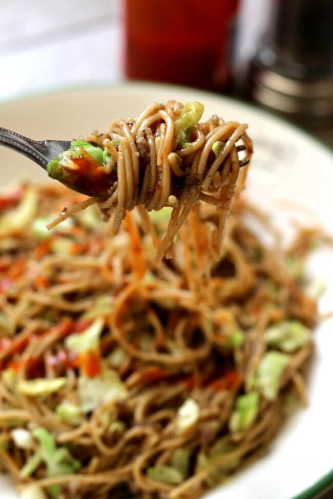 Instant Pot Pepper Noodles--thin spaghetti is tossed with tamari, pepper, ground sausage and shredded cabbage for an easy one pot meal with a lot of flare. To give it some extra kick drizzle sriracha on top of the noodles.  