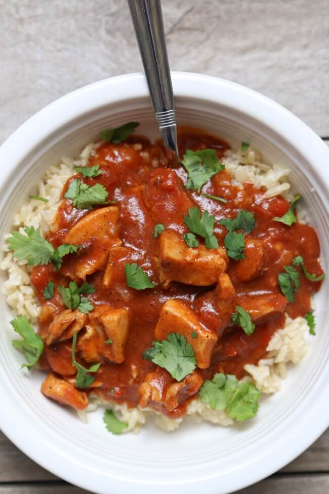 Slow Cooker Chicken Tikka Masala Recipe--tender bites of chicken in a tomato sauce with creamy coconut milk. We like to serve this with rice or naan bread. The sauce is so good I could drink it.