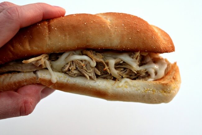 Slow Cooker Mississippi Pork Sandwiches--With just a handful of ingredients you can make fall apart pork that is perfect on sandwiches. This particular recipe has no packets of ranch or au jus. The meat is slightly spicy and infused with flavor. 