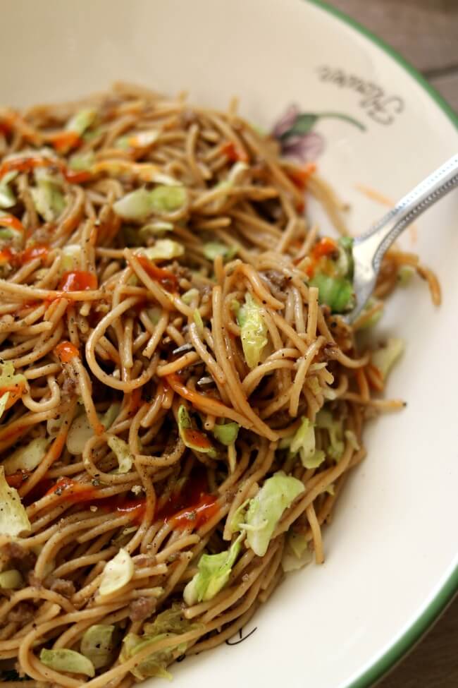 Instant Pot Pepper Noodles--thin spaghetti is tossed with tamari, pepper, ground sausage and shredded cabbage for an easy one pot meal with a lot of flare. To give it some extra kick drizzle sriracha on top of the noodles.  