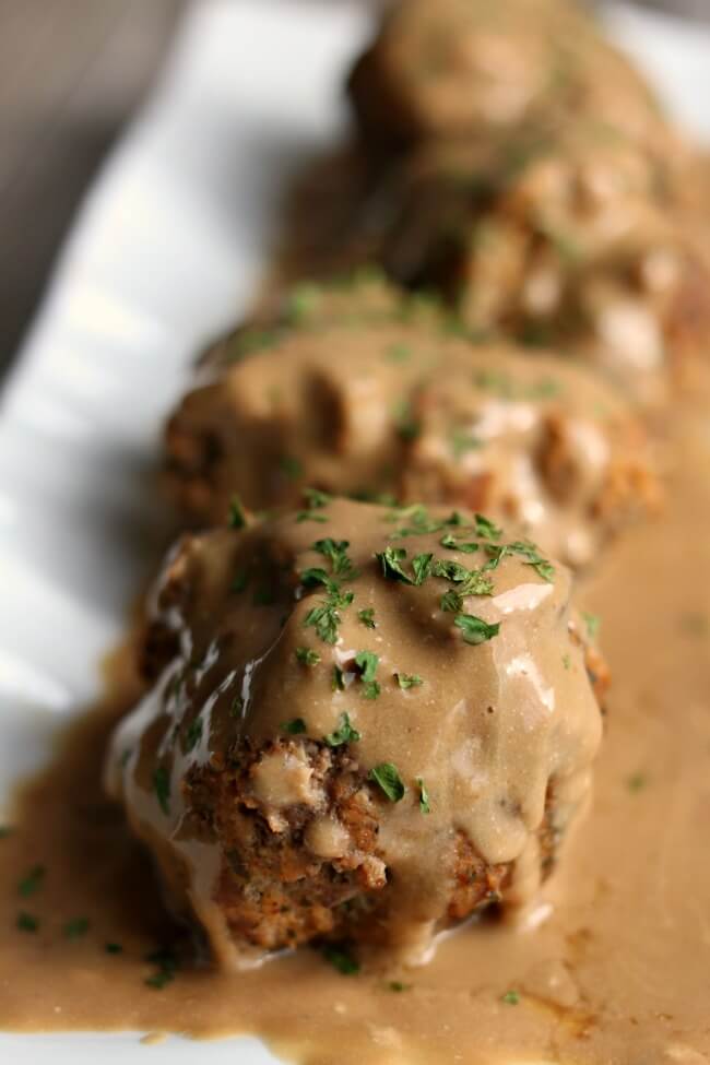Instant Pot Swedish Meatballs--ground beef and pork sausage are seasoned well and formed into meatballs and then cooked quickly in your pressure cooker. A creamy gravy smothers the meatballs for a delicious dinner you'd love to have any day of the week. 