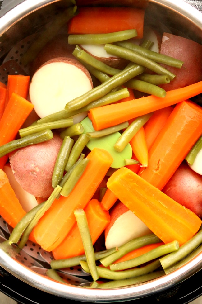 Instant Pot Homestyle Vegetables--a big pot of red potatoes, carrots and green beans steamed in your Instant Pot in a few minutes. These vegetables make a perfect side dish to a chicken or beef dinner. 