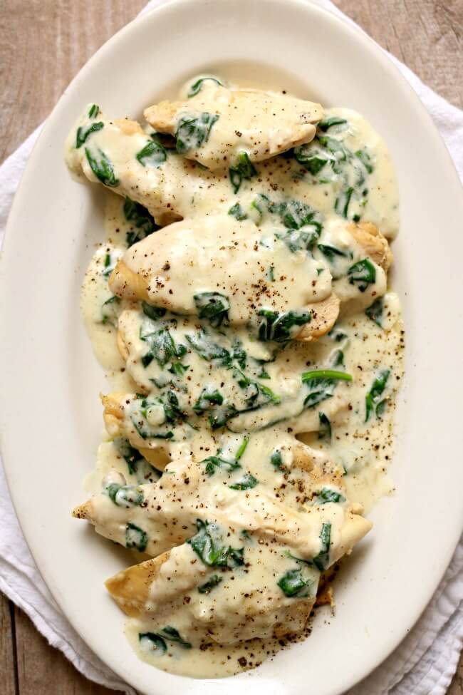 Instant Pot Garlic Parmesan Chicken--a fast and easy chicken dinner with a creamy garlic parmesan sauce with chopped spinach. We like to eat this chicken and sauce with fettuccine noodles or with mashed potatoes. 