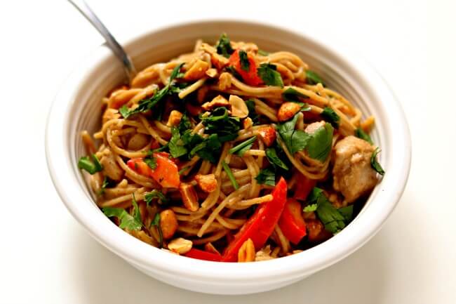 Instant Pot Thai Chicken Noodles--a true one pot meal! The chicken, sauce and noodles are all cooked at the same time in minutes in your electric pressure cooker. The noodles are enveloped in a mild creamy peanut and lime sauce and the peanuts, cilantro and red bell peppers give texture and color. A delicious and easy recipe to make any night of the week.