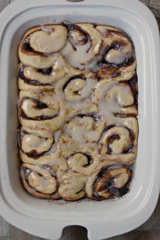 Slow Cooker Cinnamon Rolls--gooey yeast bread cinnamon rolls made easy in the slow cooker. Because they are cooked slowly you don't have to let the cinnamon roll dough raise! Cut out the step of raising the dough twice and just let the cinnamon rolls raise and cook at the same time in the slow cooker. 