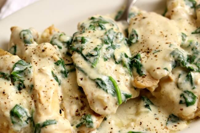 Instant Pot Garlic Parmesan Chicken--a fast and easy chicken dinner with a creamy garlic parmesan sauce with chopped spinach. We like to eat this chicken and sauce with fettuccine noodles or with mashed potatoes.